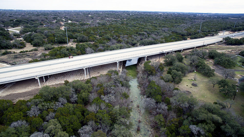 A new bridge carries the route over Bear Creek