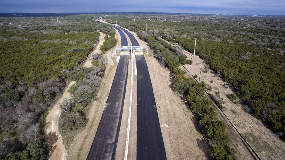 Modern tolling systems and VMS technology are installed on the gantries over the route