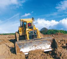 Leica scooping mud at quarry site 