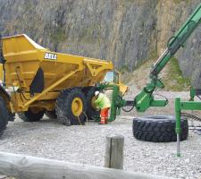 Man changing Bell dump truck tyre 