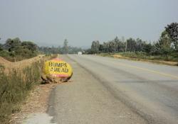 Rocky road warning sign