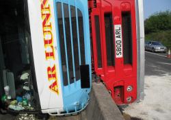 overturned bus on barrier