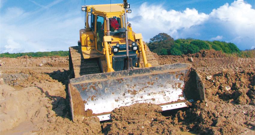 Leica scooping mud at quarry site 