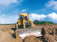 Leica scooping mud at quarry site 