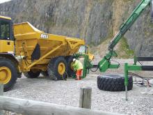 Man changing Bell dump truck tyre 