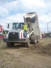 Man standing on Terex dump truck 