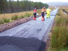 workers applying bituminous roadmesh