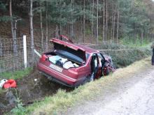 crashed car by the side of the road