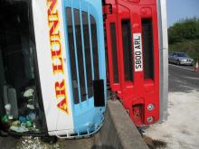 overturned bus on barrier