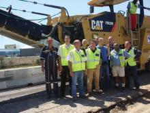 Vusela employees line up with the company's new Cat PM200 cold plane